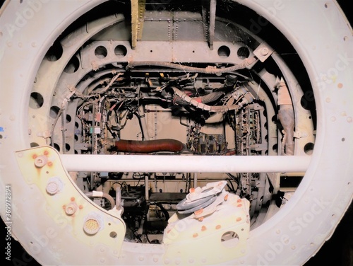 disused abandoned Helicopter tail grounded at night with lighting to show controls wiring and component parts 