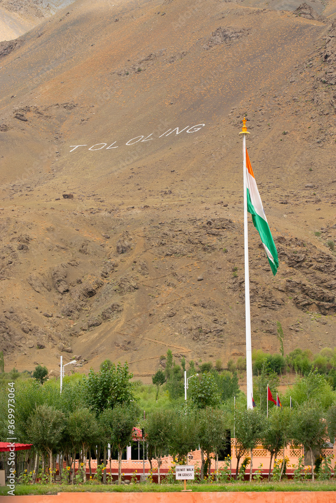 Indian national flag is waving in the bottom of mount Tololing, remembering kargil war of 1999 when Indian army won and fought back Pakistani army out of Indian territory. Kargil, Ladakh, India.