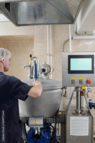 Worker Operating Meat Processing Machine photo