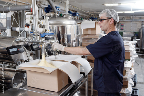Worker Monitoring Butter Packaging