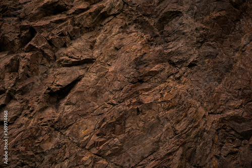 Red brown stone background. Rock surface. Mountain texture. Close-up. Bright rock background for your design.
