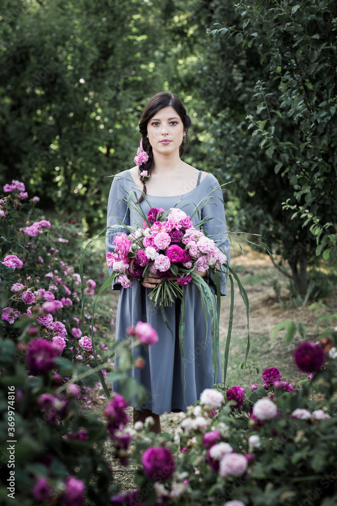 Beautiful woman with bouquet in garden Beautiful woman with bouquet in garden