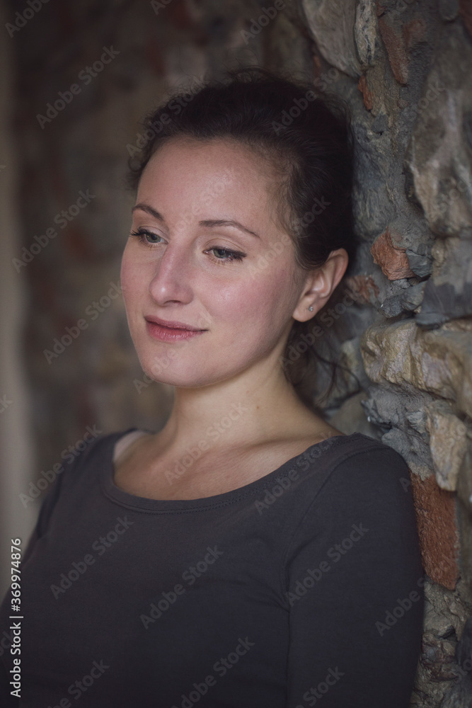 Dreamy woman at stone wall Dreamy woman at stone wall
