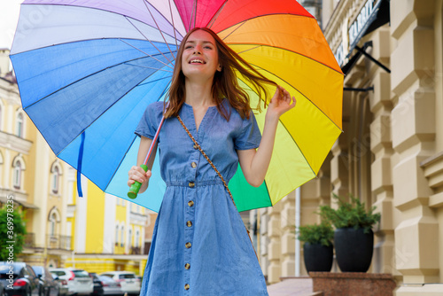 Woman with colorfull umbrella at the city center