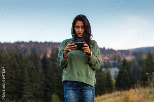Young, beautiful woman piloting a drone
