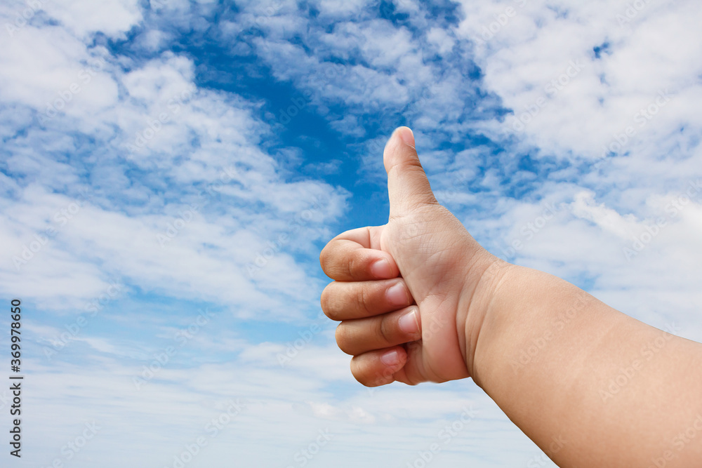 Handsbaby liking thumbs up with blue sky. Handsbaby liking thumbs up with blue sky.