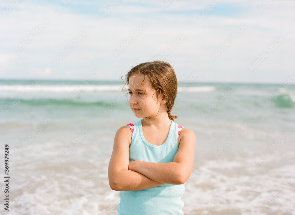 Your girl standing with her back to the ocean with her arms crossed Your girl standing with her back to the ocean with her arms crossed