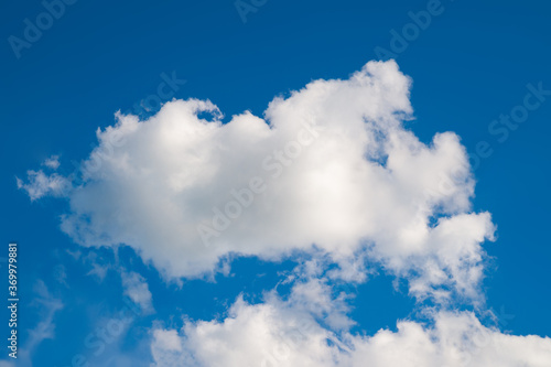 Cloudy sky. Group of cumulus clouds against the cold blue sky. Natural landscape background.