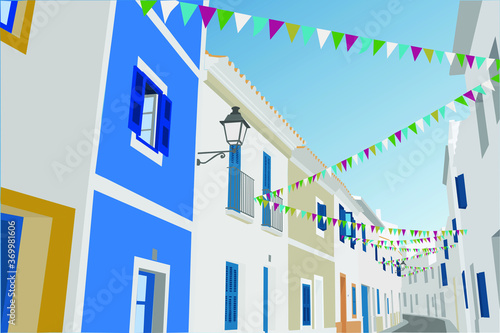 Calle de un pueblo decorada con banderines para la fiesta mayor