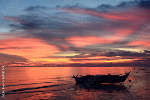 Fishing boat silhouette at dusk. White beach. Aklan. Western Visayas. Philippines