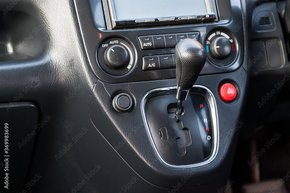 Automatic transmission gearshift knob in a black Japanese car on the central control console. Dealer warranty and recall of transmission.