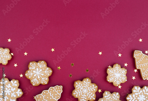 Christmas gingerbread snowflakes on a dark red background