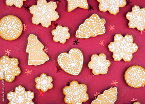 Christmas gingerbread snowflakes and Christmas trees on a dark red background