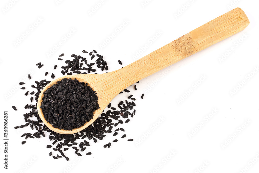 Nigella sativa or Black cumin in wooden scoop isolated on white background. Top view. Flat lay. Nigella sativa or Black cumin in wooden scoop isolated on white background. Top view. Flat lay.