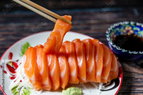 Chopsticks salmon slices in a plate