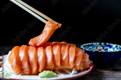 Chopsticks salmon slices in a plate