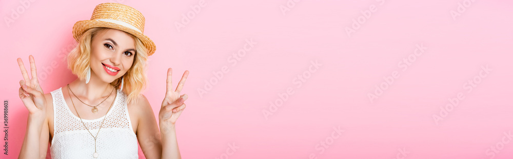 panoramic crop of woman in straw hat showing peace sign on pink panoramic crop of woman in straw hat showing peace sign on pink