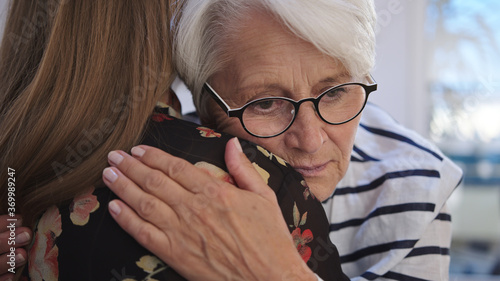 Obraz na plátně Young woman embracing an elderly lady
