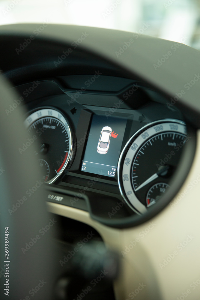 Close up shot with the digital dashboard of a car. display shows open door
