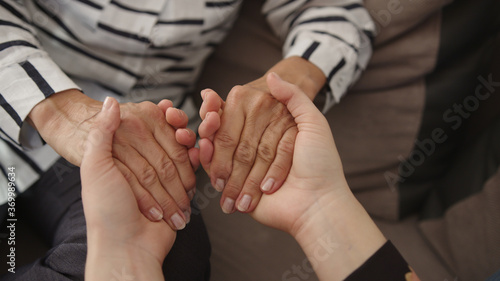 Bild auf Leinwand Close up, young woman and senior woman holding hands