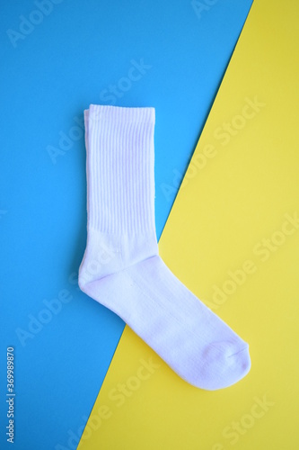 White sports socks blue and yellow background