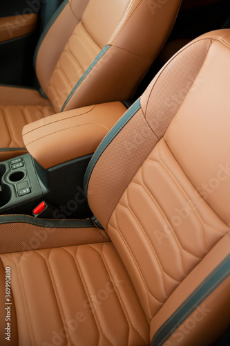 Modern Luxury car interior. Comfortable leather seats in cockpit. Modern car interior details