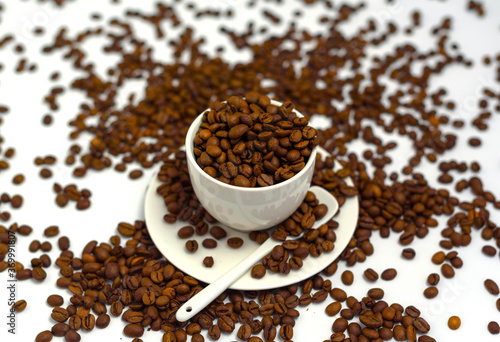 white coffee Cup and coffee beans on a white background, the concept of cheerfulness