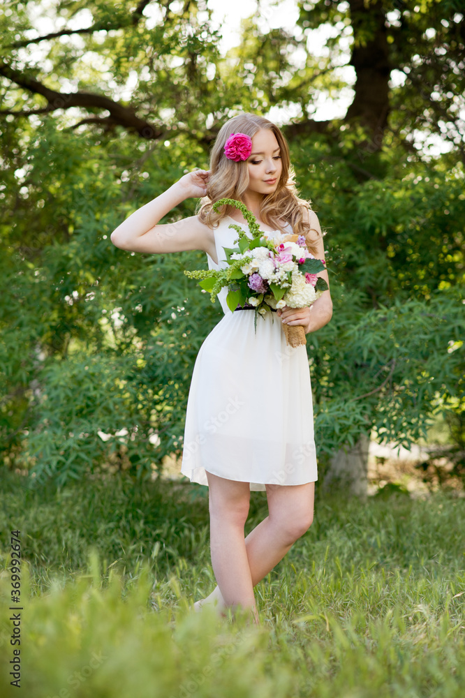 Bride. Beautiful young blond woman in the park with flower wreath and bouquet on a warm summer day. Bride. Beautiful young blond woman in the park with flower wreath and bouquet on a warm summer day.