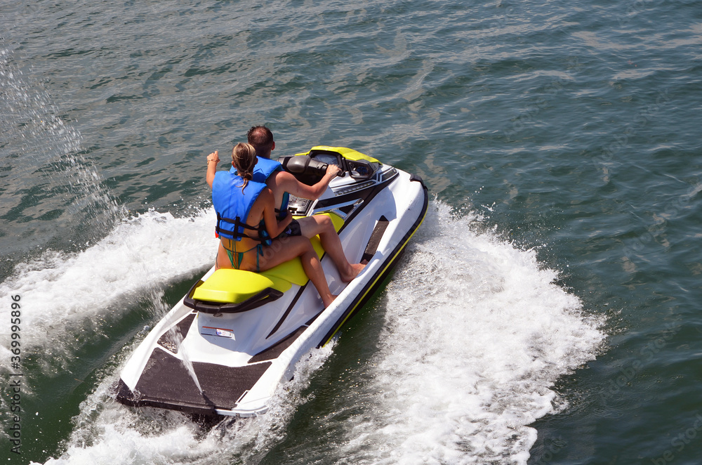 Fototapeta premium Couple riding tandem on a jetski