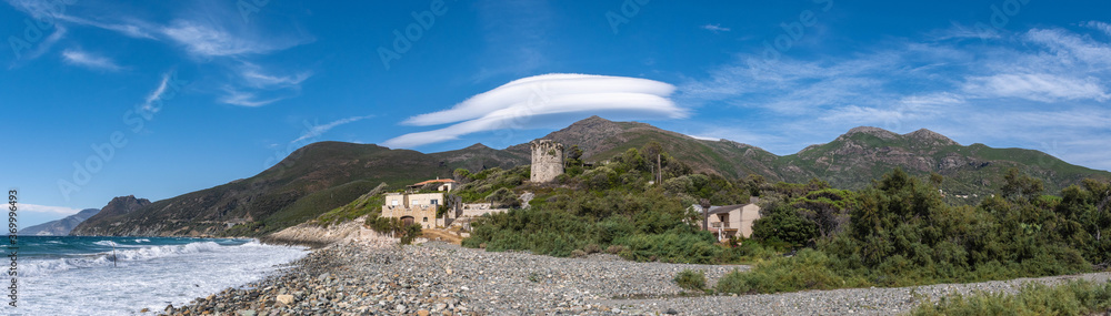 panorama of the mountains in sea under a lenticular cloud