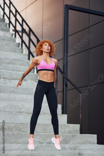 Young european redhead woman in sportive clothes outdoors