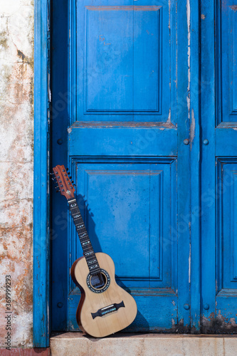 A guitar standing in the old doorway