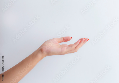 female hand holding a pill