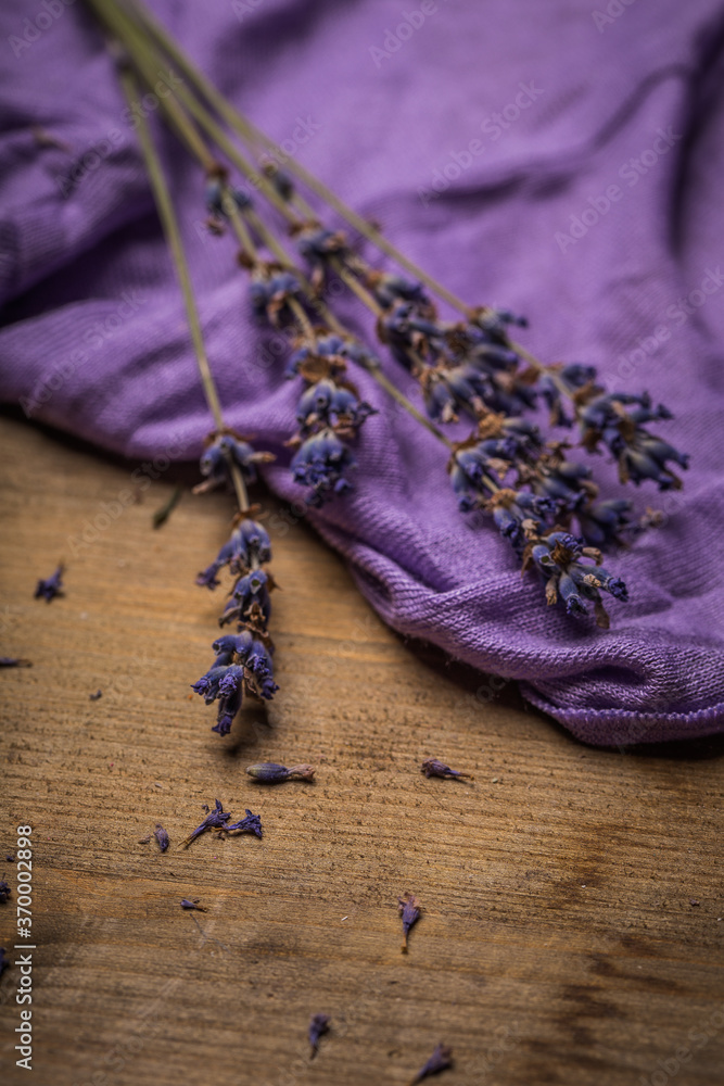 Concept of natural organic lavender oil in cosmetology. Old wooden background Concept of natural organic lavender oil in cosmetology. Old wooden background