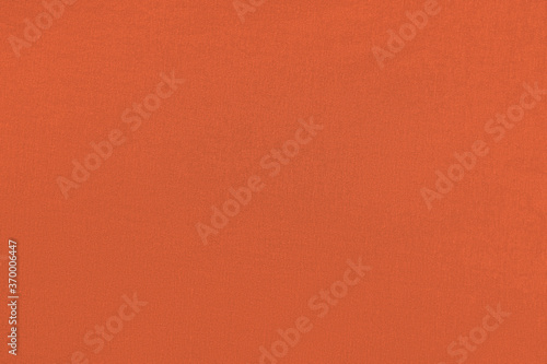 Red orange homogeneous background with a textured surface, fabric.