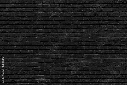 Old black brick wall background. Brick texture for design.