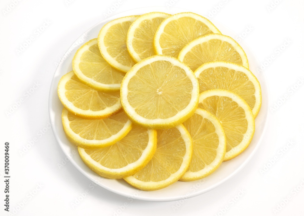 SLICES OF YELLOW LEMON citrus aurantifolia ON PLATE SLICES OF YELLOW LEMON citrus aurantifolia ON PLATE