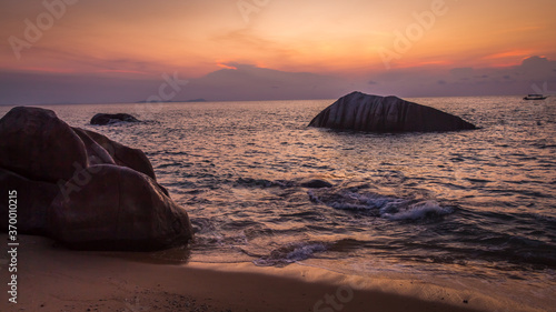 Rocks on Melina Beach at sunset, Tiomen Island, Malaysia photo