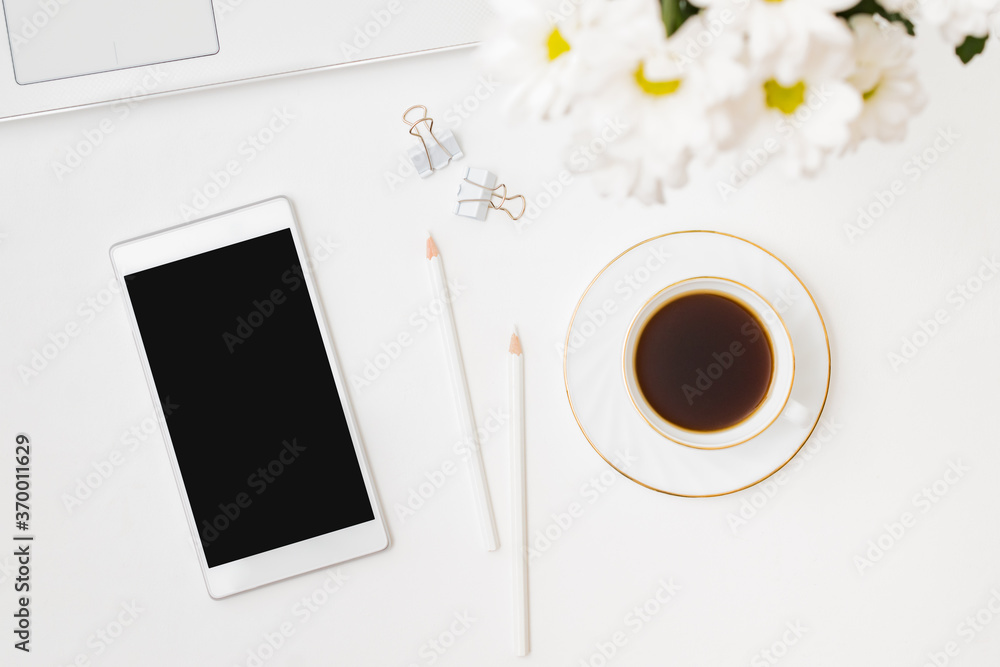 Flat lay mockup smartphone blank screen, laptop a cup of coffee on a white background Flat lay mockup smartphone blank screen, laptop a cup of coffee on a white background
