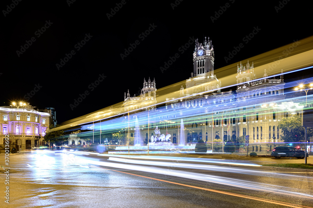 Madrid night picture in which we can see the Plaza de Cibeles, the Puerta de Alcala, the Town Hall, La casa de America and traffic of cars and buses