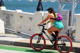 Woman riding a bike on the Venetia Causeway in Miami Beach,Florida