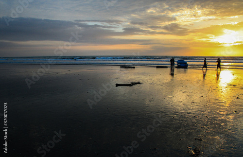 Sunset at beautiful beach at Canoa  pacific coast  Puerto Lopez  Manat    Ecuador with silhouettes of people