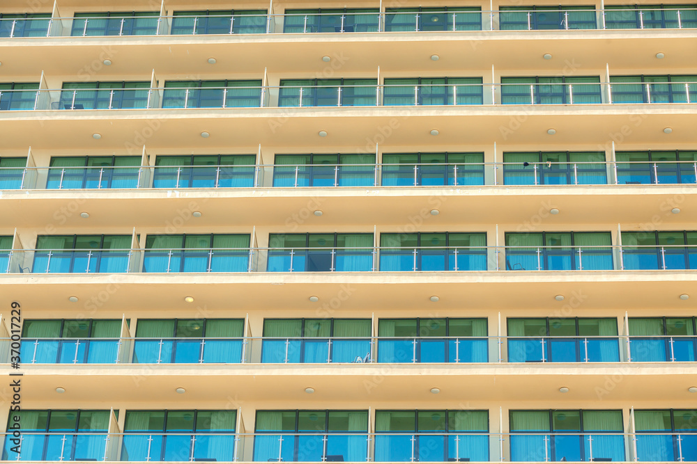 Fragment of a high-rise building with Windows and balconies Fragment of a high-rise building with Windows and balconies