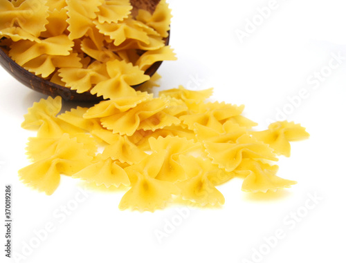 Close up of the background farfalle in wooden bowl on white background