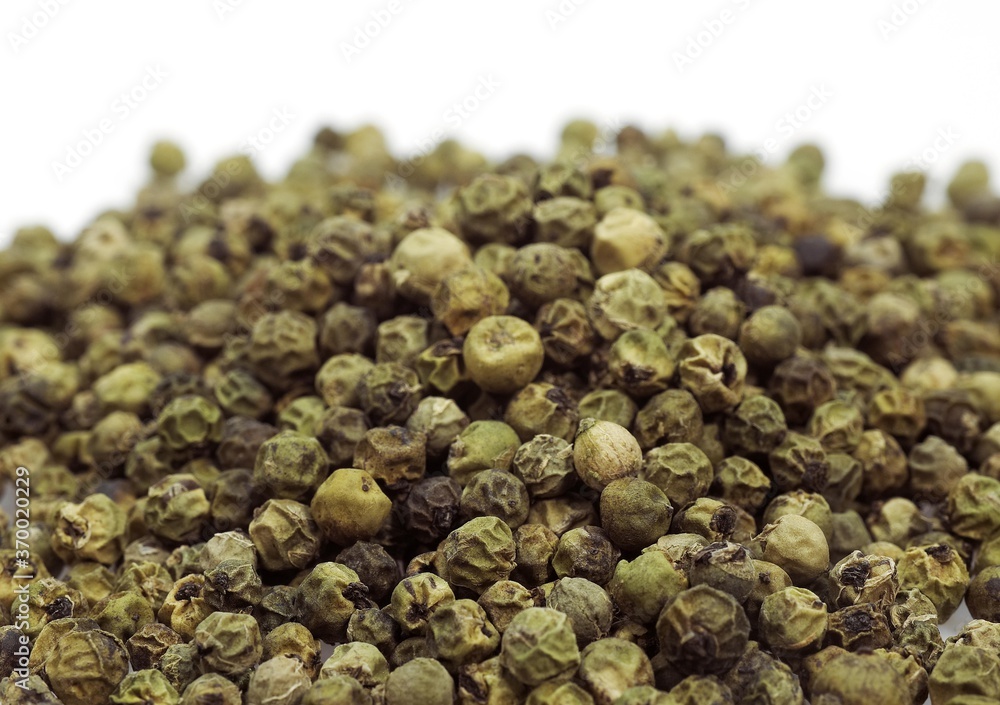 GREEN PEPPERCORN AGAINST WHITE BACKGROUND GREEN PEPPERCORN AGAINST WHITE BACKGROUND