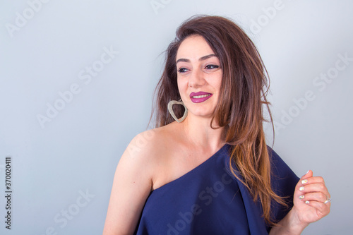 happy beautiful woman in blue dress in studio
