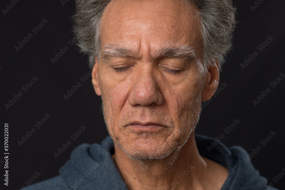 Distraught unshaven senior man at home looking depressed and tired of being locked down Distraught unshaven senior man at home looking depressed and tired of being locked down