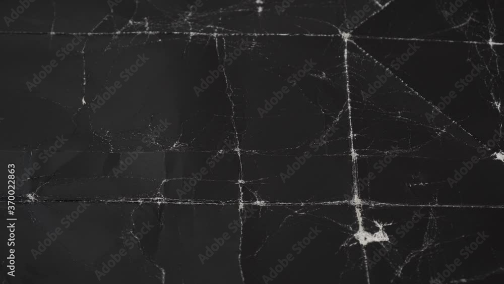 Crumpled black cardboard with wrinkles and wrinkled folds. Old wrapping dusty paper. Abstract dramatic background Crumpled black cardboard with wrinkles and wrinkled folds. Old wrapping dusty paper. Abstract dramatic background