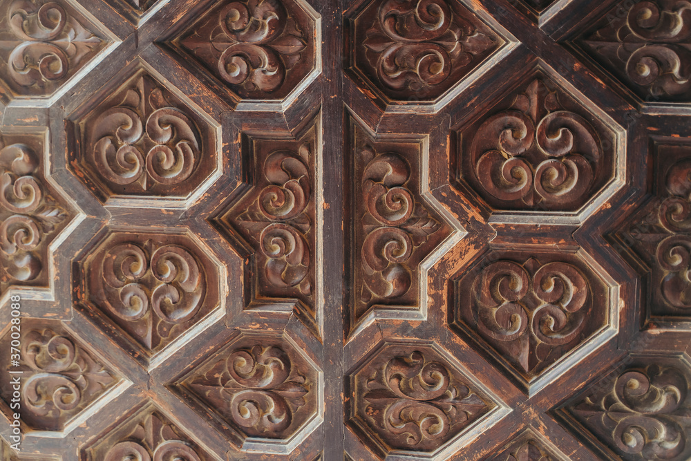 Moorish engravings wallpaper on a door.