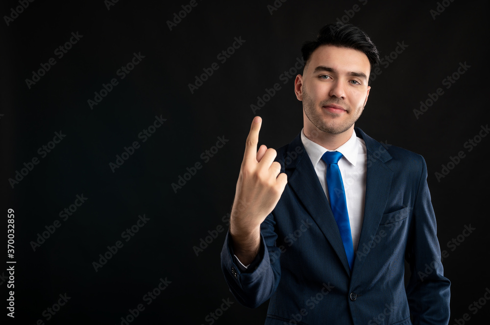Portrait of business man wearing blue business suit and tie showing number one Portrait of business man wearing blue business suit and tie showing number one
